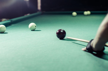Billiard player now preparing his shot the ball