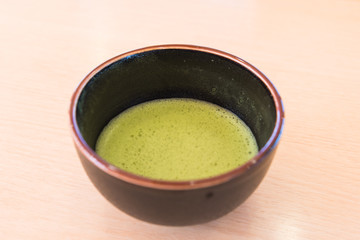 fresh green tea in traditional cup