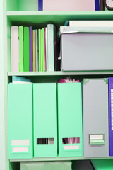 The image of folders on a shelf