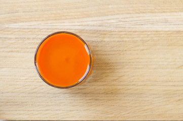 Obraz na płótnie Canvas Carrot juice in glass. View from top.