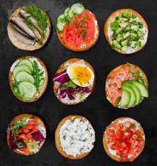 Various bruschettas on black rustic background