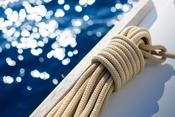 Yachting background - rope on board of small yacht - sail boat with sea in background