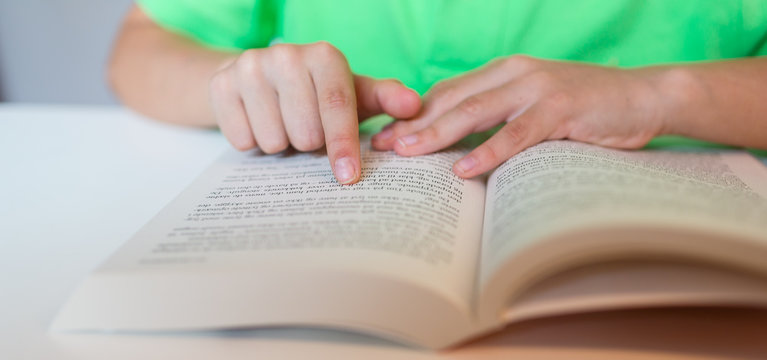 Close-up of person reading a book