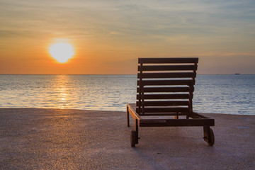 Beach chair on beach at sunset