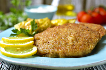 Viennese schnitzel on a blue plate.