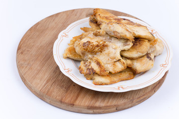 Grilled chicken breasts on the plate isolated over white