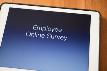 tablet on table with online employee survey
