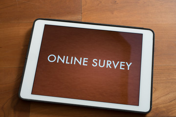 tablet on table with online customer survey