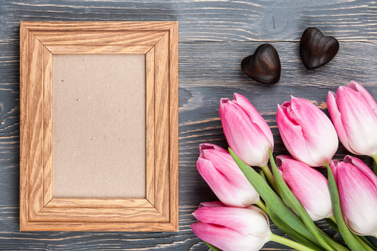 Fresh pink tulips and blank frame