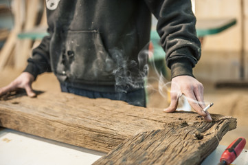 Carpenter smoking cigarette in workshop