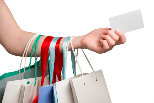 woman hand with many bags and credit card on a white background
