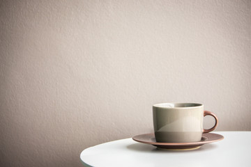 Cup of coffee on a white wooden table.