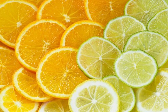 Healthy background with colourful slices of oranges, lime and lemon