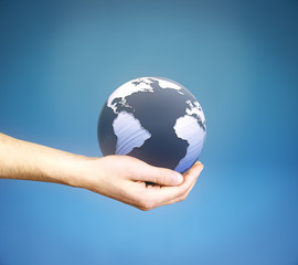 Hand with globe on blue