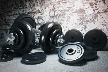 Dumbbell and plates on floor