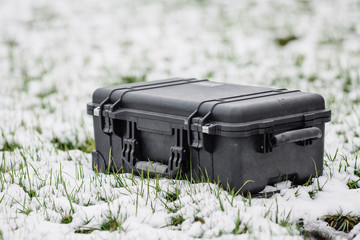 plastic black protector case lying on the grass and snow