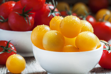 Red and yellow cherry tomatoes in a white porcelain bowl on the
