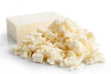 Rolgordijnen Crumbled white feta cheese isolated on white. © Moving Moment