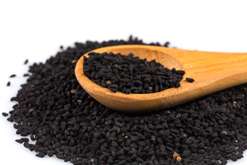 Heap of black sesame on wooden spoon