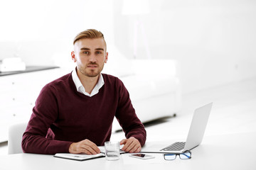 Fototapeta premium Businessman working with laptop in office