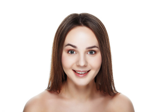 Beauty portrait of pretty SURPRISED girl with natural makeup. Beautiful spa woman touching her face. Perfect fresh skin. Pure beauty model girl. Youth and skin care concept