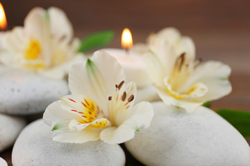 Spa still life with stones, flowers and candlelight closeup