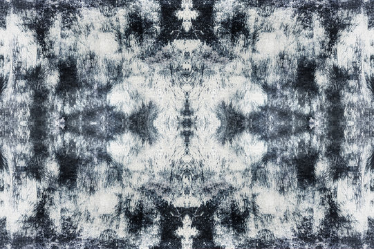 Abstract black and white texture of the wall, background pattern, with central symmetry, in ethno, grunge, batik style.