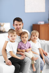 Obraz premium Family concept. Father with sons are in the room