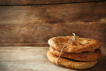 Fresh fried bread on wooden background