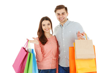 Young couple with colorful shopping bags isolated on white