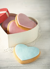 Valentine heart cookies in present box on wooden background