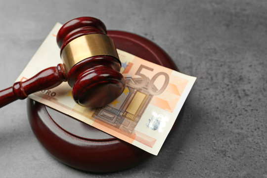 Law gavel with euro on grey background, closeup