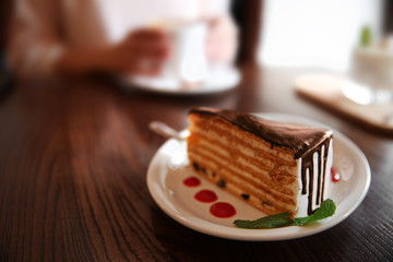 Tasty chocolate cake on table in cafe or restaurant
