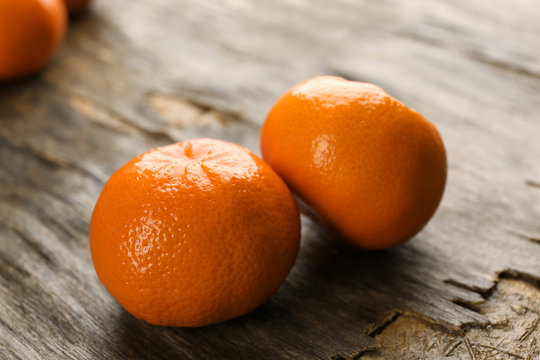 Fresh, delicious tangerines on a rustic table, close up