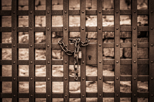 metal gate locked with a padlock and a chain