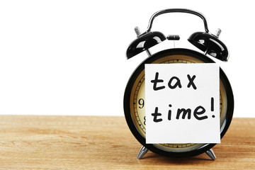 Tax time on alarm clock on table