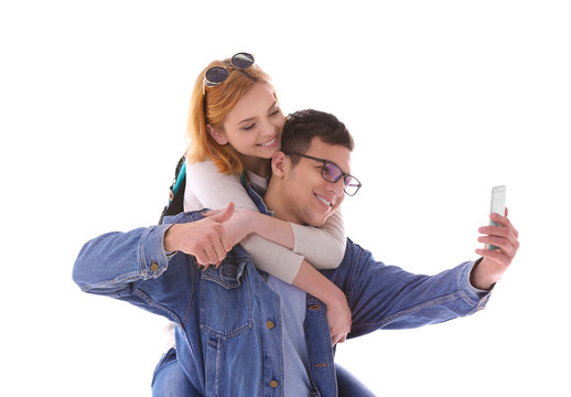 Young couple taking selfie with mobile phone isolated on white