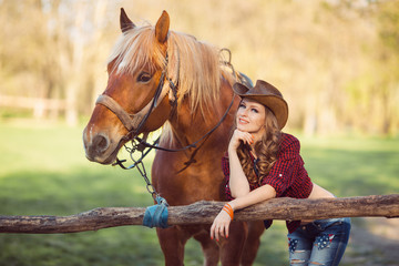 Horse and girl with cowboy hat