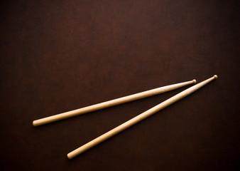Couple of drum sticks on wooden desktop