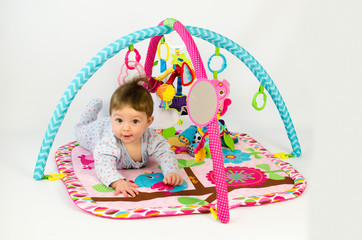 baby girl playing in an activity gym