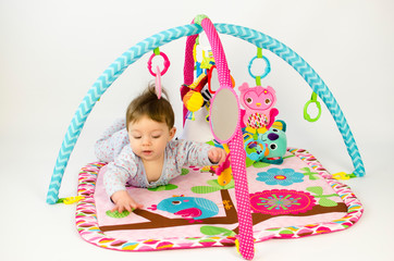 baby girl playing in an activity gym