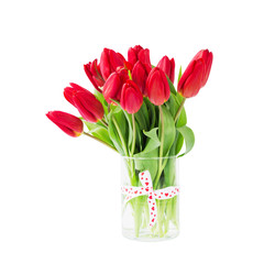 Red tulips bouquet in vase decorated with ribbon. Isolated over white background