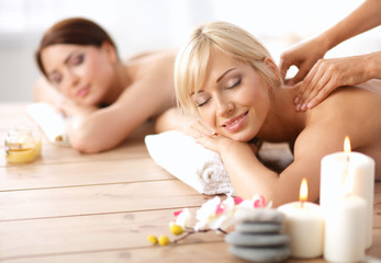 Fototapeta na wymiar Two young beautiful women relaxing and enjoying at the spa center