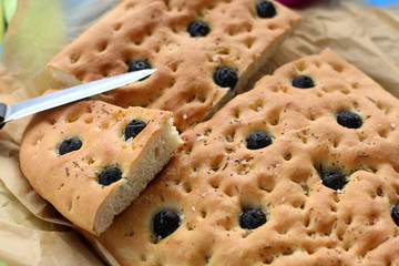 Homemade mediterranean bread with olives, served on a picnic. Selective focus.