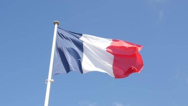 Slow motion of famous French flag fabric waving in front of blue sky 1920X1080 FullHD footage - Tricolor flag of France slow-mo flowing by the day 1080p HD video 