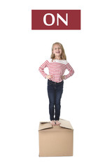 sweet blond hair child stading on top of cardboard box isolated on white background  in learning...