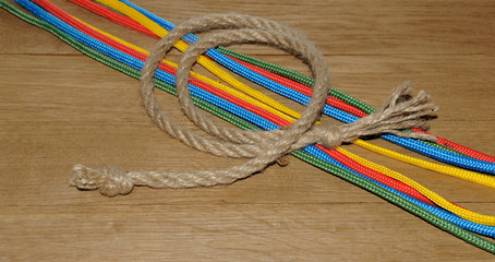 Colorful ropes on  wooden background