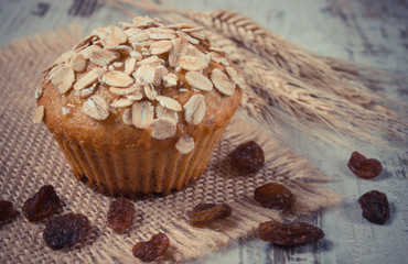 Vintage photo, Fresh muffin with oatmeal baked with wholemeal flour and ears of rye grain, delicious healthy dessert
