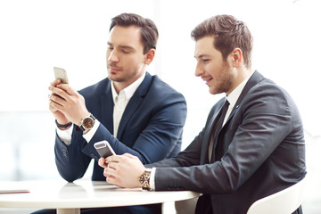 Pleasant business men using mobile phones