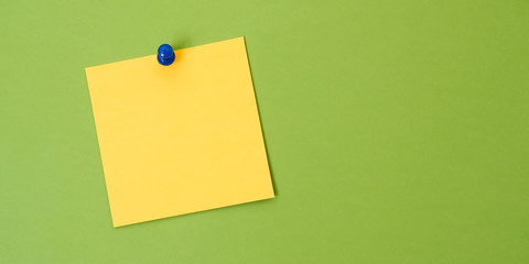 Blank Yellow Note Paper on a Green Board